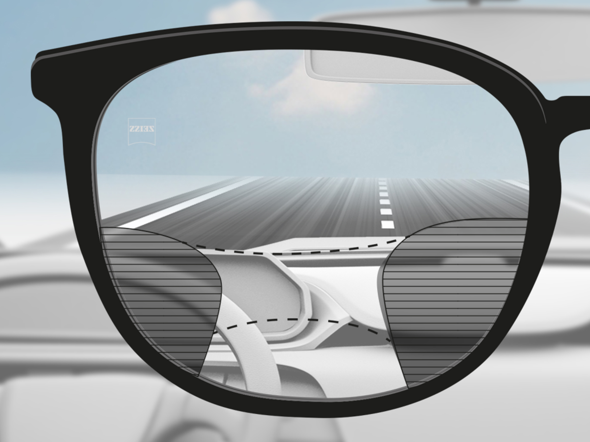 Saját nézőpontból készült kép egy ZEISS Progressive DriveSafe lencséről: a látózónák úgy vannak kialakítva, hogy a sofőr éles látózónákon tekintsen át, amikor az utat vagy a műszerfalat nézi.
